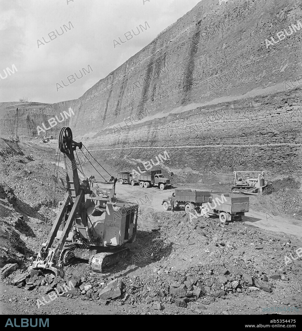JOHN LAING PLC. The last tons of coal being extracted from the opencast mine at Carrington's Coppice, with a 178 ft deep cut looming above. John Laing and Son Ltd had started opencast mining operations in 1942 to meet wartime needs. The work was expanded by the company after the war. Carrington's Coppice was the largest site that the company worked and was the deepest opencast site in Britain. Work started in 1947 and by 1949 the seam was worked out after 523,623 tons of coal had been extracted from the site. By August 1950 the land was reinstated for agricultural use.