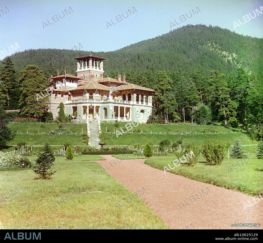 SERGEY MIKHAYLOVICH PROKUDIN-GORSKY. General view of the Likanskii Palace from the Kura River, between 1905 and 1915. The Likany foothills of the Caucasus Mountains provide a dramatic backdrop for a palace built on the Kura River, close to the Russian border with Turkey and near the town of Borzhomi in present-day Georgia. The Romanov Palace, also known as Likani Palace, was designed by Leon Benois for {/30401/}. Russian chemist and photographer Sergey Prokudin-Gorsky (1863-1944) was a pioneer in colour photography which he used to document early 20th-century Russia and her empire, including the vanishing way of life of tribal peoples along the Silk Route in Central Asia. In a railway-carriage darkroom provided by Czar Nicholas II, Prokudin-Gorsky used the three-colour photography process to record traditional costumes and occupations, churches and mosques - many now Unesco World Heritage sites - as well as modernisation in agriculture, industry and transport.