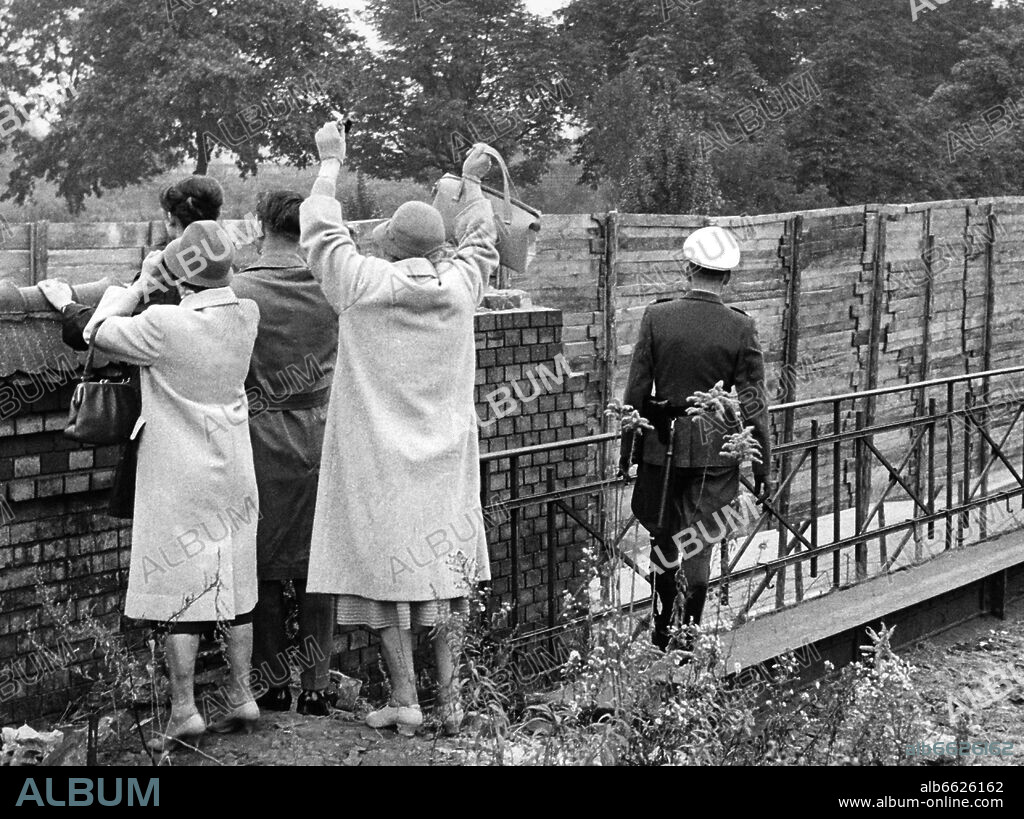 Citizens of West Berlin wave across the Berlin wall at the so-called Gleimtunnel on 15 October 1961. The Berlin Wall was errected on 13 August 1961 under the watchful eyes of GDR's armed forces. It was aimed to stop the flood of refugees from East to West. 15/10/1961