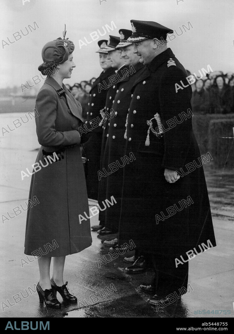 The Queen Visits Her Naval Airmen - The Queen chatting with commodore Sir Aubrey St. Clair Ford, commodore of the Barracks (right), on her arrival at the Royal Naval Barracks, Lee-on-Solent, today (Friday). Paying her first visit to a naval establishment since her Accession , The Queen today (Friday) visited The Royal Navy's Home Air Command at Lee-on-Solent, Hampshire. She travelled from London by rail to Fort *****, completing her journey by car, which was escorted by two S.51 Weatland Sikeraky Dragonfly helicopters - the type that has been operating on rescue work behind enemy lines in Korea. November 21, 1952. (Photo by Reuterphoto).