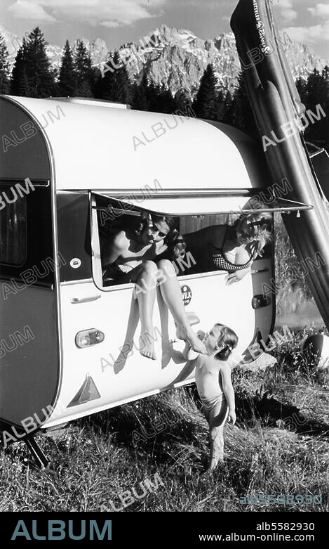 Travel / Car:. Caravan. Young women and a little girl at the window of a caravan (made by Wilk); a dinghy made by Metzeler AG next to it. Photo (advertising shot), June 1967.