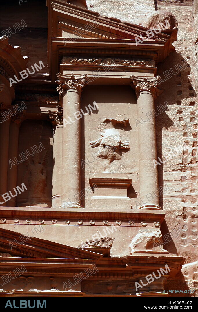 Al-Khazneh (The Treasury) a temple in the ancient Nabatean Kingdom city of Petra, Jordan. The structure was carved out of a sandstone rock face and is believed to have been the mausoleum of the Nabatean King Aretas IV in the 1st century AD. It is one of the most popular tourist attractions in both Jordan and the region. In 1812, the city of Petra and Al-Khazneh was rediscovered by Swiss explorer Johann Ludwig Burckhardt.