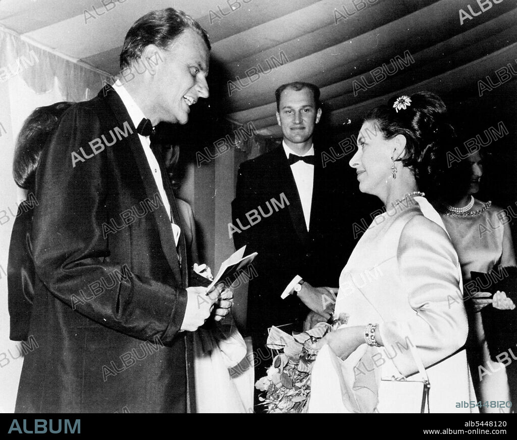 Return of the Hot-Goseller -- Royalty...Princess Margaret met Billy Graham at the Tower of London in 1954. Billy Graham converted thousands to the cause of Christianity when he hit England in 1954, filling Wembley Stadium and rocking the foundation of English theocracy with his Bible-thwacking, old time religion. Since then, the man has come under a lot of flak for his life style and his blatant commercialism. At Oxford Town Hall on Friday 1st February, he stood up once again, bruised and battered following a fall from grace in the shower of his hotel bathroom, end still managed to impress an audience of a sceptics who had come to hear him over-simplify religion. What they got instead was one man's view of the Message, cracked around the edges but with ***** on during ***** truth to bolster his showmanship. February 01, 1930. (Photo by Daily Mirror).
