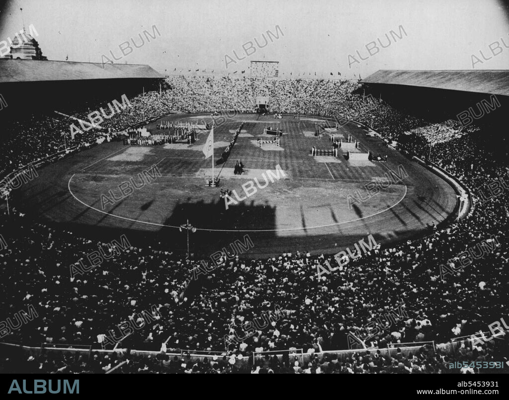 Closing Of The Games Of The XIV Olympiad : A General view inside Wembley Stadium, Aug. 14, showing crowd at the handing over of the Olympic flag to the Lord mayor of London who will retain the flag till the XV Olympiad is celebrated in Helsinki. In this picture the Olympic flag is flying at centre, the flame is seen at background whilst on tribune of honour at left stand J. Sigfrid Edstrom, President of the International Olympic Committee and Sir Frederick Wells, Lord Mayor of London. August 14, 1948. (Photo by Rota Picture).