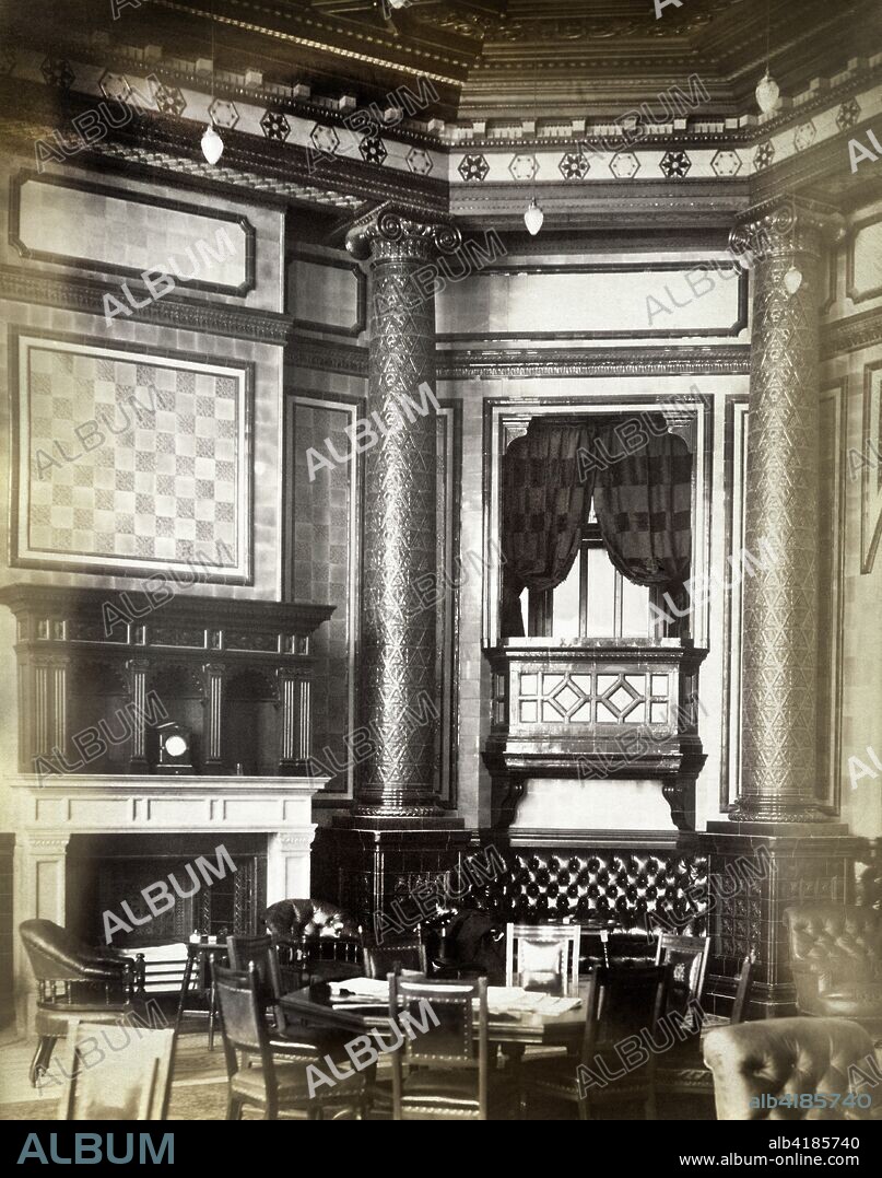 Smoking room, National Liberal Club, Whitehall Place, Westminster, London, 1887. Interior detail of fireplace and collonaded corner niche. The National Liberal Club was built in 1884-1887 to designs by the architect Alfred Waterhouse. The image is one of a set commissioned by the club.