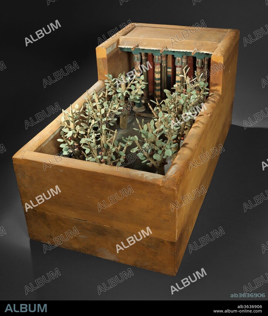 Model of a Porch and Garden. Dimensions: L. 84.4 cm (33 1/4); W. 42.5 cm (16 3/4 in); H. 39.5 cm (15 9/16). Dynasty: Dynasty 12. Reign: reign of Amenemhat I, early. Date: ca. 1981-1975 B.C..
This model of a garden and portico was discovered in a hidden chamber at the side of the passage leading into the rock cut tomb of the royal chief steward Meketre, who began his career under King Nebhepetre Mentuhotep II of Dynasty 11 and continued to serve successive kings into the early years of Dynasty 12.
In the center of the garden is a pond surrounded by sycamore fig trees with red fruit growing from the trunks and branches. The pond is lined with copper and could have been filled with water. Facing the garden is the porch of a house.  Two rows of columns support the roof made of palm trunks split into halves.  The rear columns have capitals in the form of papyrus stalks bound together, the capitals of the front columns imitate bundles of lotus. Rainfall is rare in Upper Egypt, but such an eventuality is provided for in three projecting spouts.  At the back of the portico are two doors and a latticed window.  These are depicted in more detail also on the outside of the model. The garden model is in essence a libation basin (the pool) with associated vegetation and architecture.  There may be links with the so-called "soul houses," clay models of houses with representations of offerings in the forecourts.
All the accessible rooms in the tomb of Meketre had been robbed and plundered already during Antiquity; but early in 1920 the Museum's excavator, Herbert Winlock, wanted to obtain an accurate floor plan of the tomb's layout for his map of the Eleventh Dynasty necropolis at Thebes and, therefore, had his workmen clean out the accumulated debris. It was during this cleaning operation that the small hidden chamber was discovered, filled with twenty-four almost perfectly preserved models. Eventually, half of these went to the Egyptian Museum, Cairo, and the other half came to the Metropolitan Museum in the partition of finds.