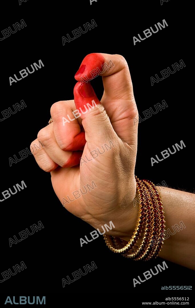 Woman hand showing Kapittha hasta (hand gesture) (also called mudra) (meaning "Godess Lakshmi") of indian classic dance Bharata Natyam. Also used in Indian dances Odissi and Kuchipudi. kapittha Godess Lakshmi