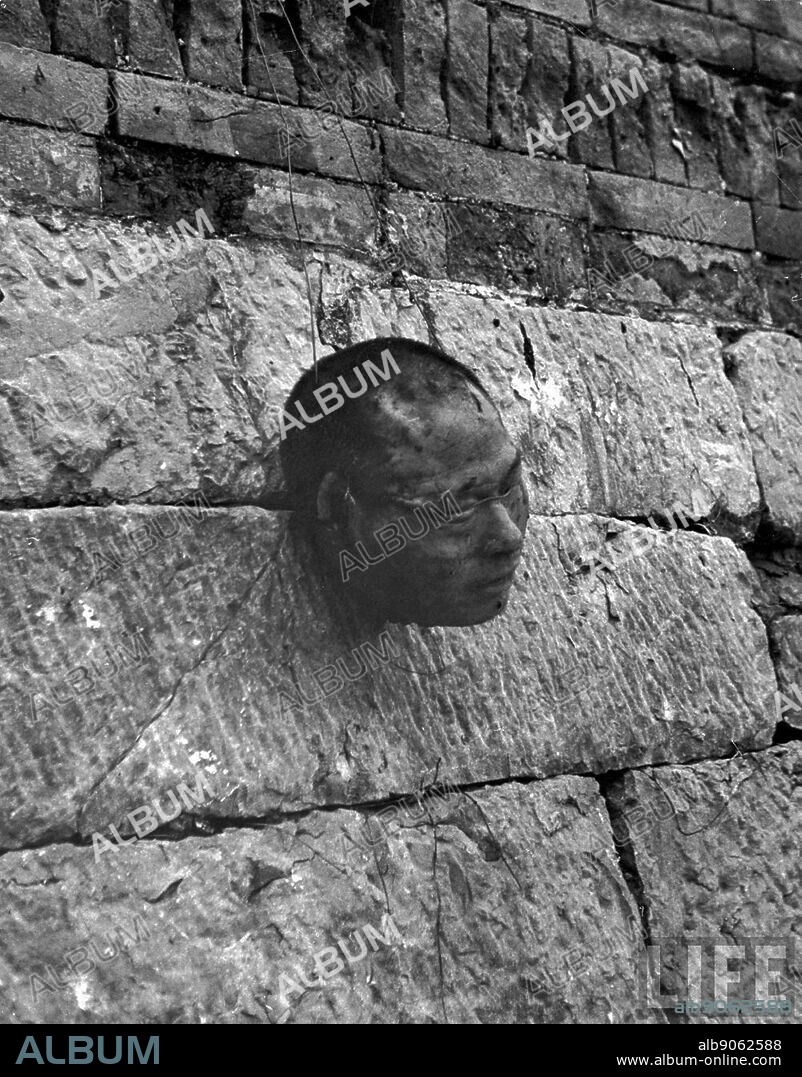 Image shows a decapitated head of the Communist guerrilla leader Ting Hsi-Shan. He was executed by Chinese Nationalists. They placed his head on a wall, in a village near Shanghai. Dated February 1948.