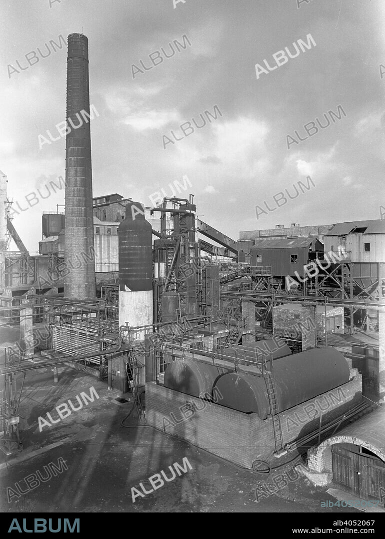 Wath Main Colliery, Wath upon Dearne, near Rotherham, South Yorkshire, 1956. The pit was originally sunk in 1876 to a depth of 382 yards and deepened in 1912 the reach the higher quality coal of the Park Gate seam. In the late 1950s the pit was connected by a diesel roadway to Manvers Main colliery, from where coal mined at Wath was brought to the surface. The last coal was mined in Wath in 1986 and just prior to closure around 400, 000 tonnes per year were being produced.