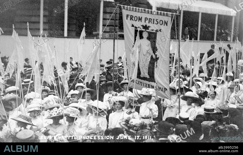 The 'From Prison to Citizenship' banner on the Women's Coronation Procession, London, 17th June 1911. Lawrence Housman designed this banner for the Kensington Women's Social and Political Union in 1908. The Prisoners' Pageant marches immediately behind the suffragette leaders and in front of the historical pageant of women.