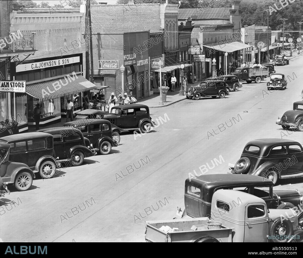 WALKER EVANS. County seat of Hale County, Alabama. [C.A. Johnson & Son ready-to-wear cash store; McCollum Grocery Co.; Loftis Cafe; drugstore; barber shop; Gulf gas station].