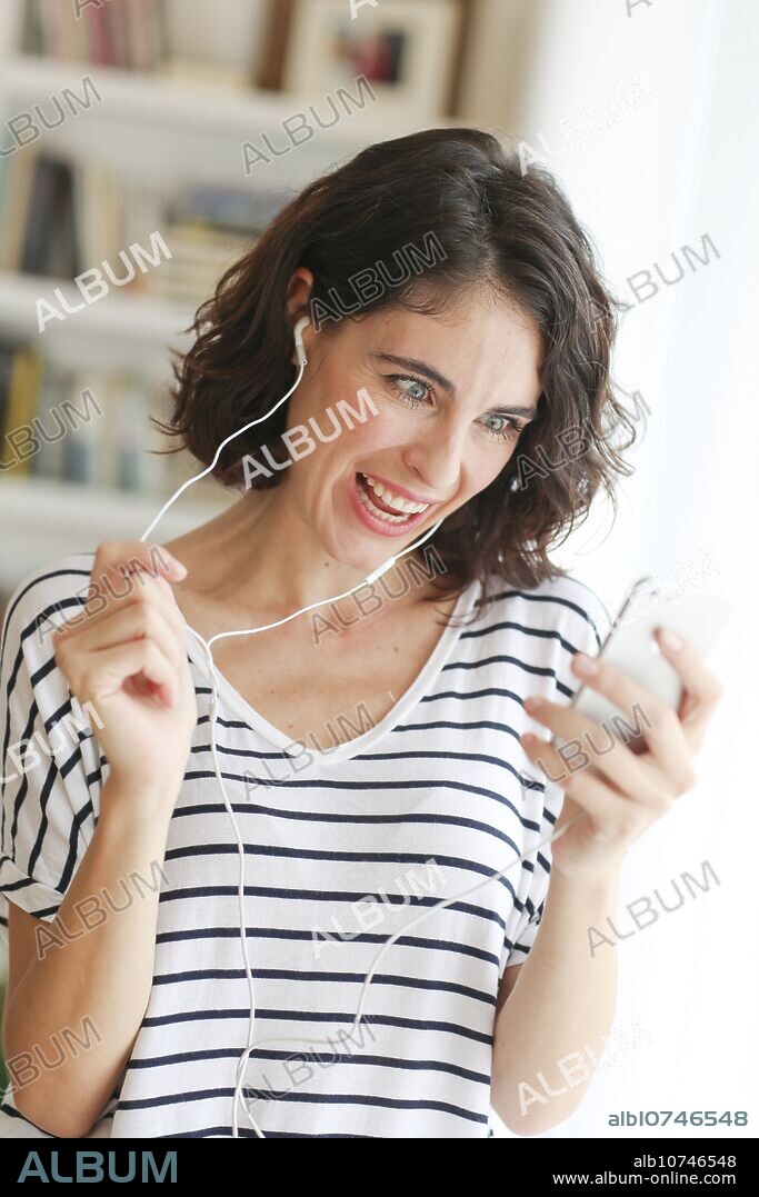 Woman listening music with Smartphone.