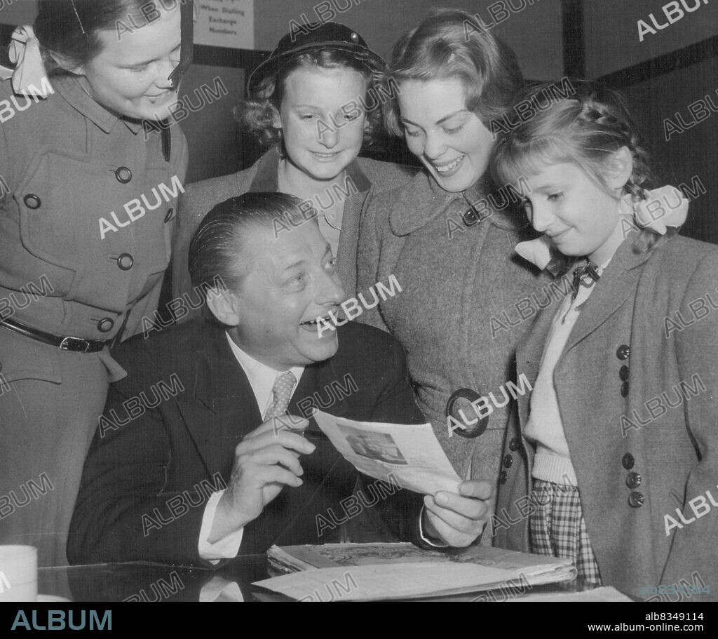 Dr. Hans Schmidt-Isserstedt, visiting German conductor, explains the pronunciation of his name to four eager photograph hunters after a concert at the Town Hall this afternoon.The girls are left to right : Julia Ryan, 14 years of Gordon., Margaret Chambers, 12 years of Hurstville, Janet Harvey, 15 years of Lane Cove, Rosemary Chambers, 8 years of Hurstville.This was the Doctor's farewell concert, he leaves tomorrow for Adelaide. August 09, 1953. (Photo by Stuart William MacGladrie/Fairfax Media).