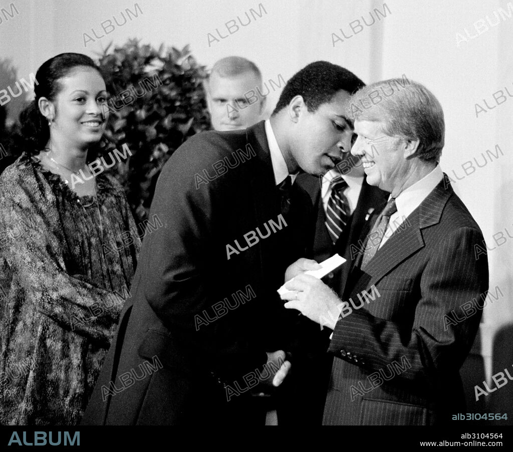 President Jimmy Carter greets Muhammad Ali at a White House dinner celebrating the signing of the Panama Canal Treaty, Washington, D.C. 1977.