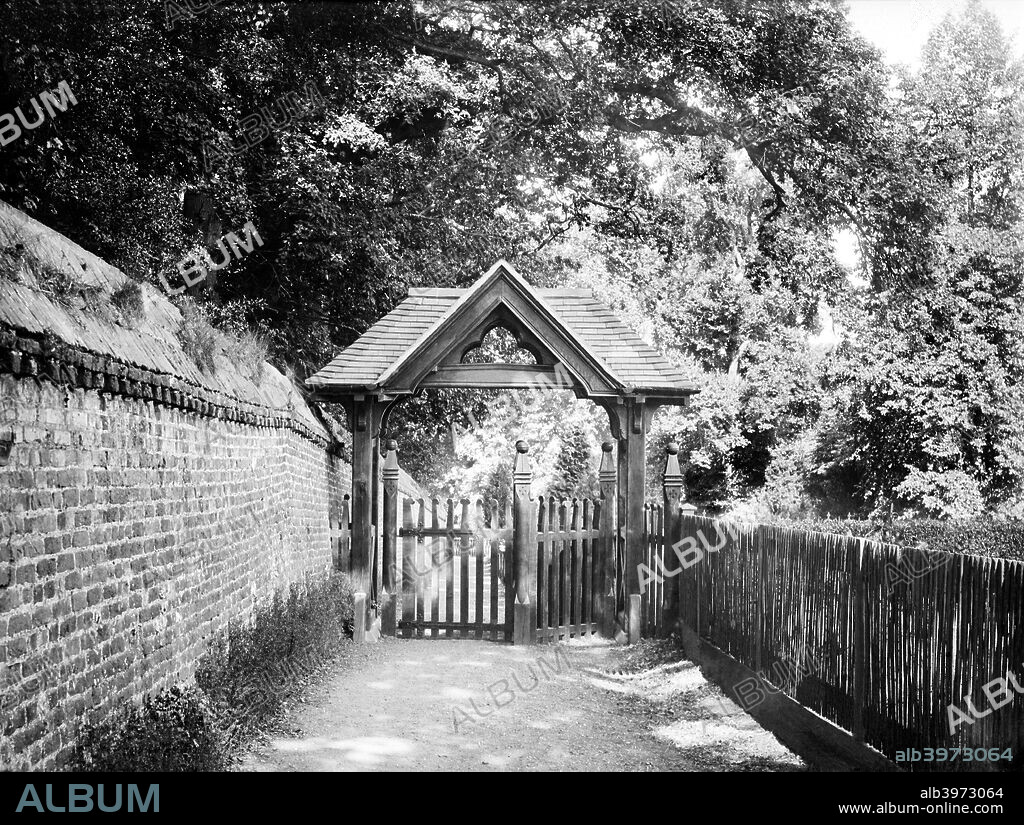 Lych gate of St Andrew's Church, Sonning, Berkshire, c1860-c1922. The wooden lych gate of the church, built in the Victorian period, with a narrow lane behind.