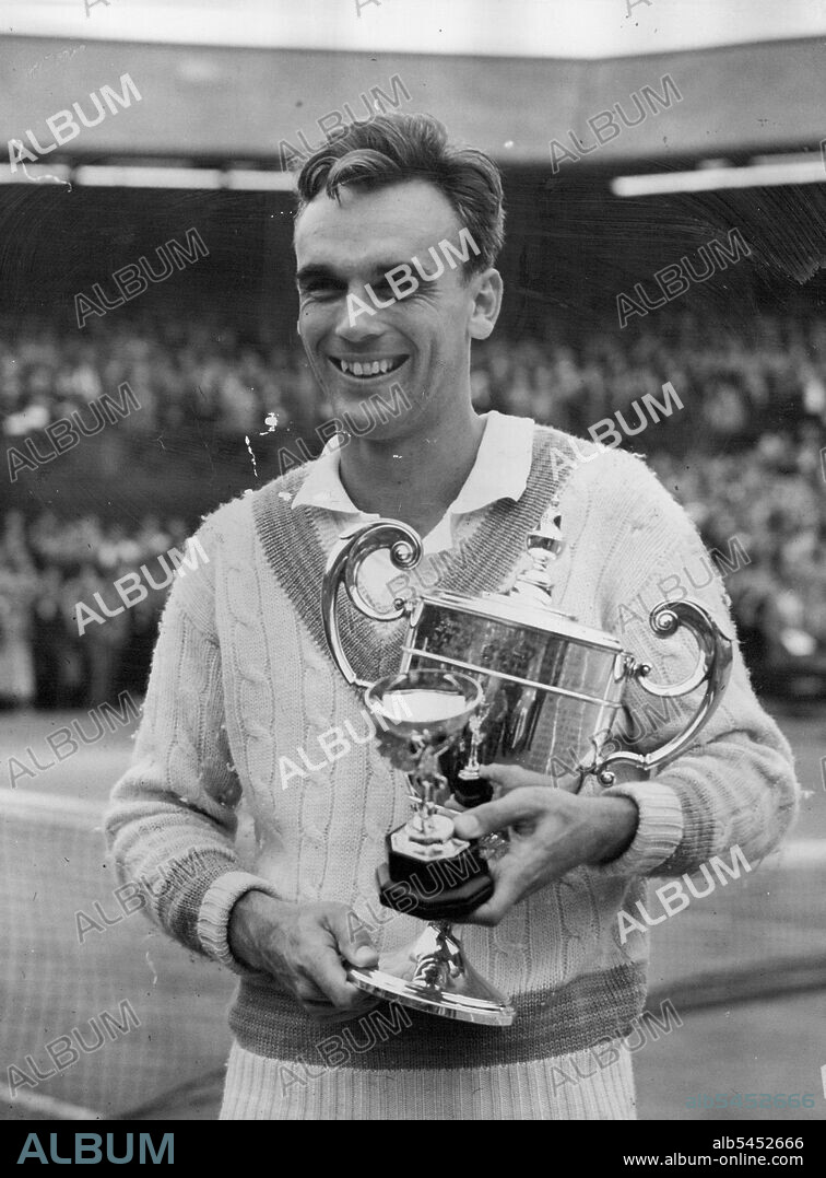 Victor Victorious :The Smile of A Champion -- Victor Seixas, 29-year-old American, gives the smile of victory as he holds the cup which he received from the Duchess of Kent after winning the final of the Men's Singles at the Wimbledon Tennis Tournament. He beat Denmark's 22-year-old Kurt Nielsen 9-7, 6-3, 6-3. July 03, 1953.