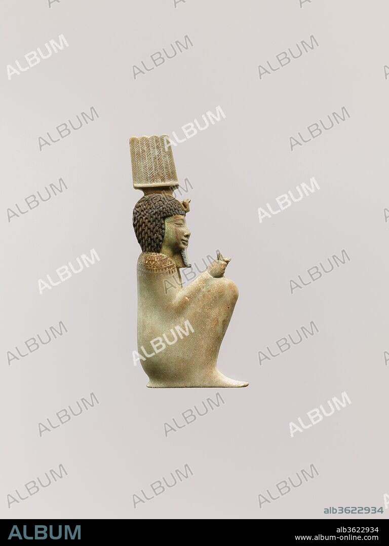 Inlay of the squatting god Anhur (Onuris). Dimensions: H. 8.8 cm (3 7/16 in.); W. 3.7 cm (1 7/16 in.); D. 1.5 cm (9/16 in.). Date: 4th century B.C..
This small crouching figure is the god Onuris. He is distinguished by his crown of four upright feathers.Originally he held a scepter in the fist on his knee. The king Nectanebo II incorporated into his royal names epithets relating him to the god Onuris.