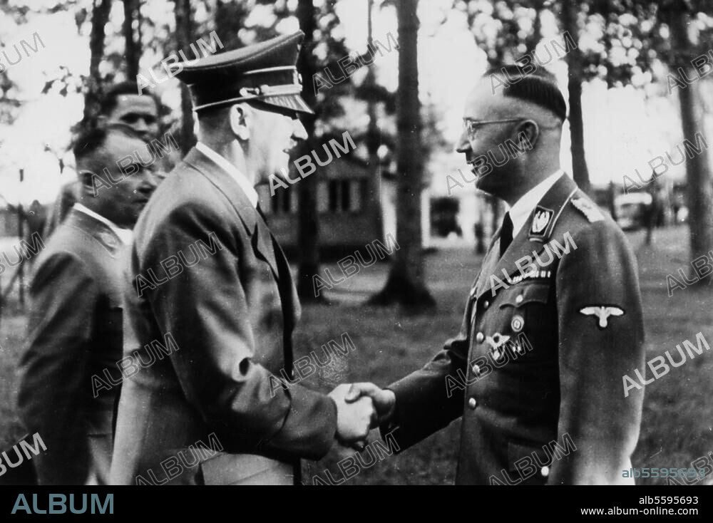 Himmler, Heinrich, politician (NSDAP), Munich 7/10/1900 - (suicide) near Lüneburg 23/5/1945. Hitler wishes Himmler happy 43th birthday at Wolfschanze, the headquarter of the Führer; Martin Bormann behind Hitler. Photo.