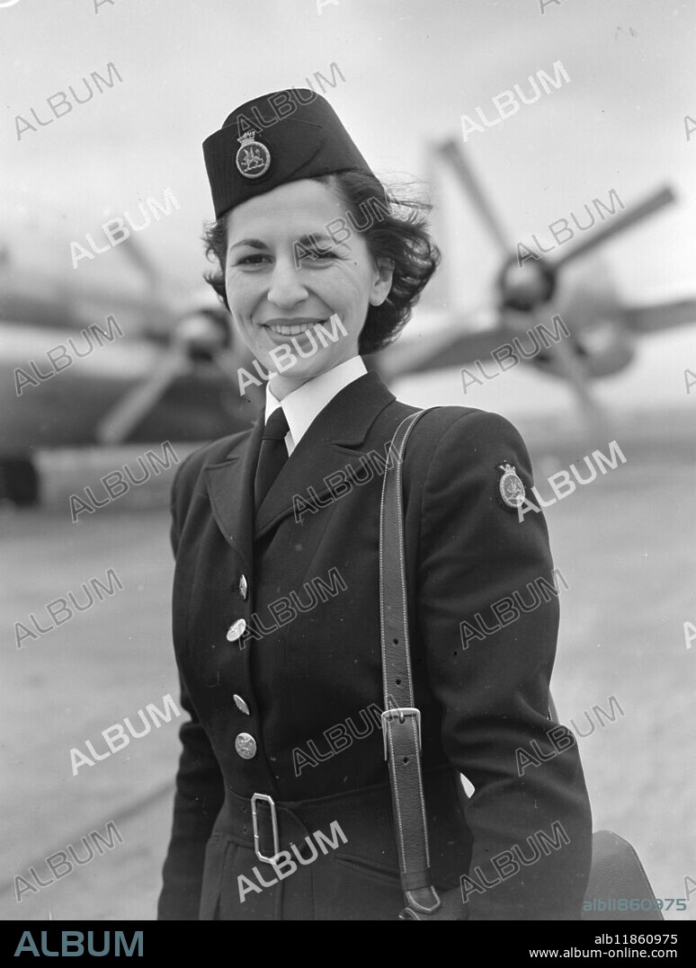 NEW GIRLS FOR B.O.A.C. Susan Chandler of Chester, Cheshire one of the six new air stewardesses to serve on B.O.A.C. long distance craft. Pictured here at London airport , Paula Francis of London. The girls have been trained by B.O.A.C. and will serve on regular flights to Hong Kong, Singapore, and Bahrei'n on the Persian Gulf. 11 March 1950.