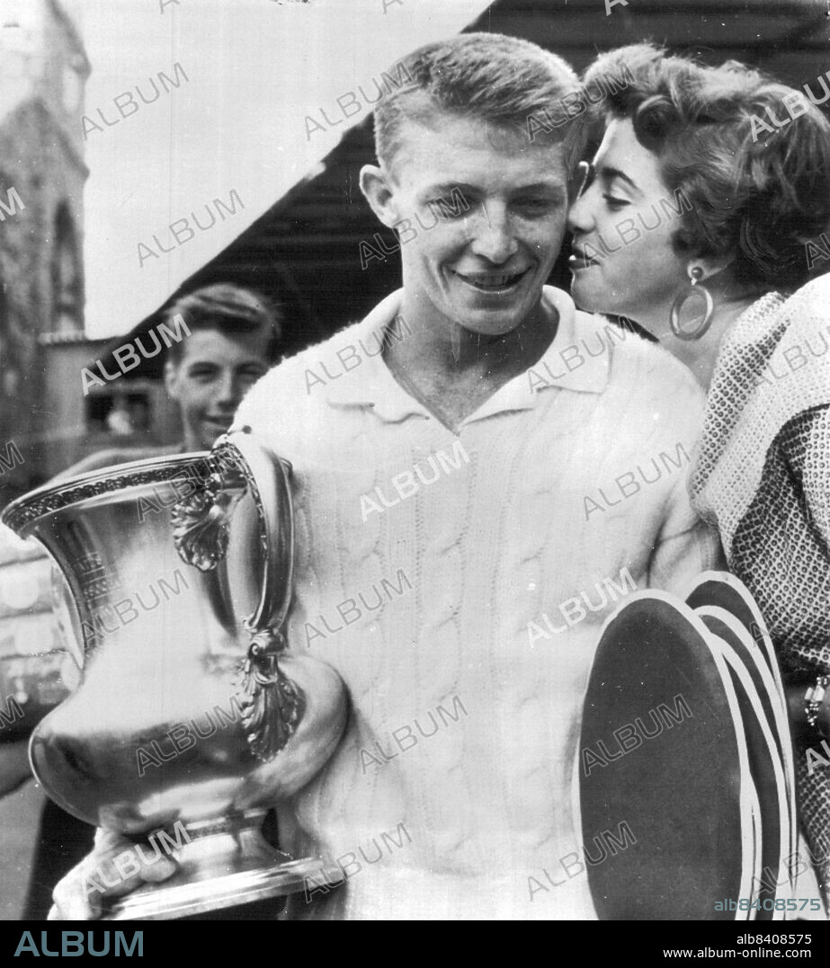 Tony Collects Second 'Award' -- New U.S. tennis champ Tony Trabert holds trophy as he gets kiss from his fiancee, Shauna Wood, here today after upset Victory for title over Wimbledon King Vic Seixas of Philadelphia. The 23-year-old ex-sailor from Cincinnati beat Seixas, 6-3, 6-2, 6-3. In winning title, he swept through six opponents with out losing a set. Tony and Miss Wood, of Salt Lake City, Utah, plan to marry next January. September 07, 1953. (Photo by AP Wirephoto).