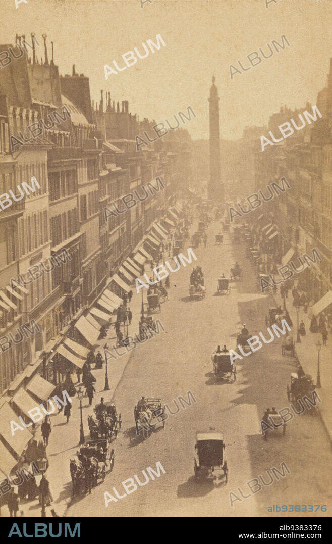 Street view of Rue de la Paix, Paris, Rue de la Paix (title on object), Carte-de-visite, so-called instantanée, showing early street view to Place Vendôme in Paris, with moving carriages and people walking., anonymous, Paris, c. 1865, cardboard, paper, albumen print, height 101 mm × width 64 mm.