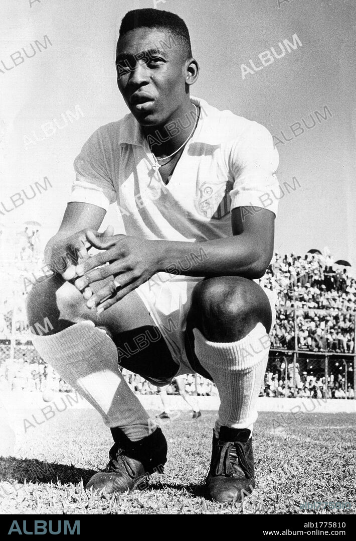 Pele on a football field. Edson Arantes do Nascimento, also called Pele, squatting on a football field. 1961.