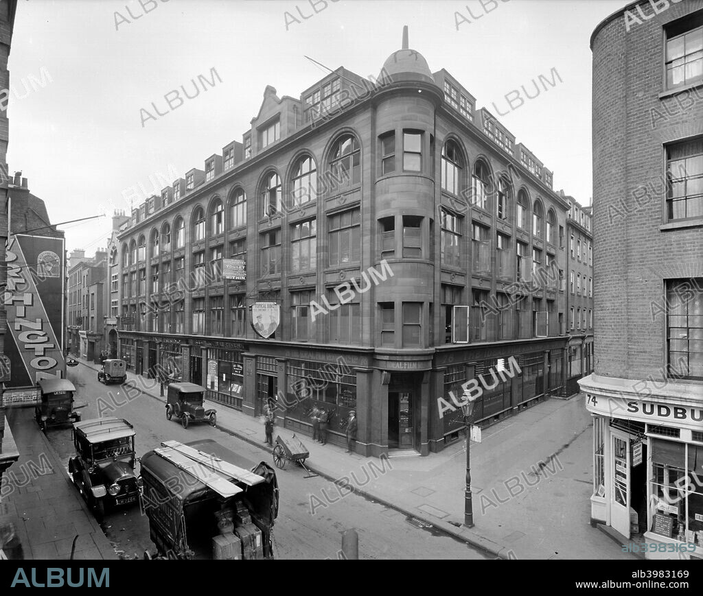 76-88 Wardour Street, Westminster, London, 1923. This building was designed by William Woodward in 1906-8. Its ground floor houses several cinema-related firms, eg The Ideal Film Renting Co. A number of delivery vehicles are parked outside beneath an advertising hoarding for Worthington's beer.