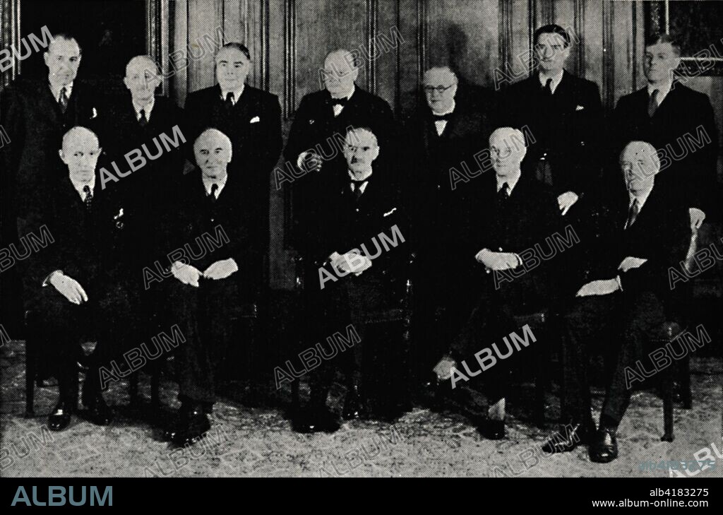 'The Original War Cabinet, 1939', (1945). British politicians at the start of the Second World War. Standing from left to right: Sir John Anderson, Lord Hankey, Leslie Hore-Belisha, Winston Churchill, Sir Kingsley Wood, Anthony Eden, Sir Edward Bridges. Seated from left to right: Lord Halifax, Sir John Simon, Prime Minister Neville Chamberlain, Sir Samuel Hoare and Lord Chatfield. From "The Life and Times of Winston Churchill", by Malcolm Thomson. [Odhams Press Limited, London].