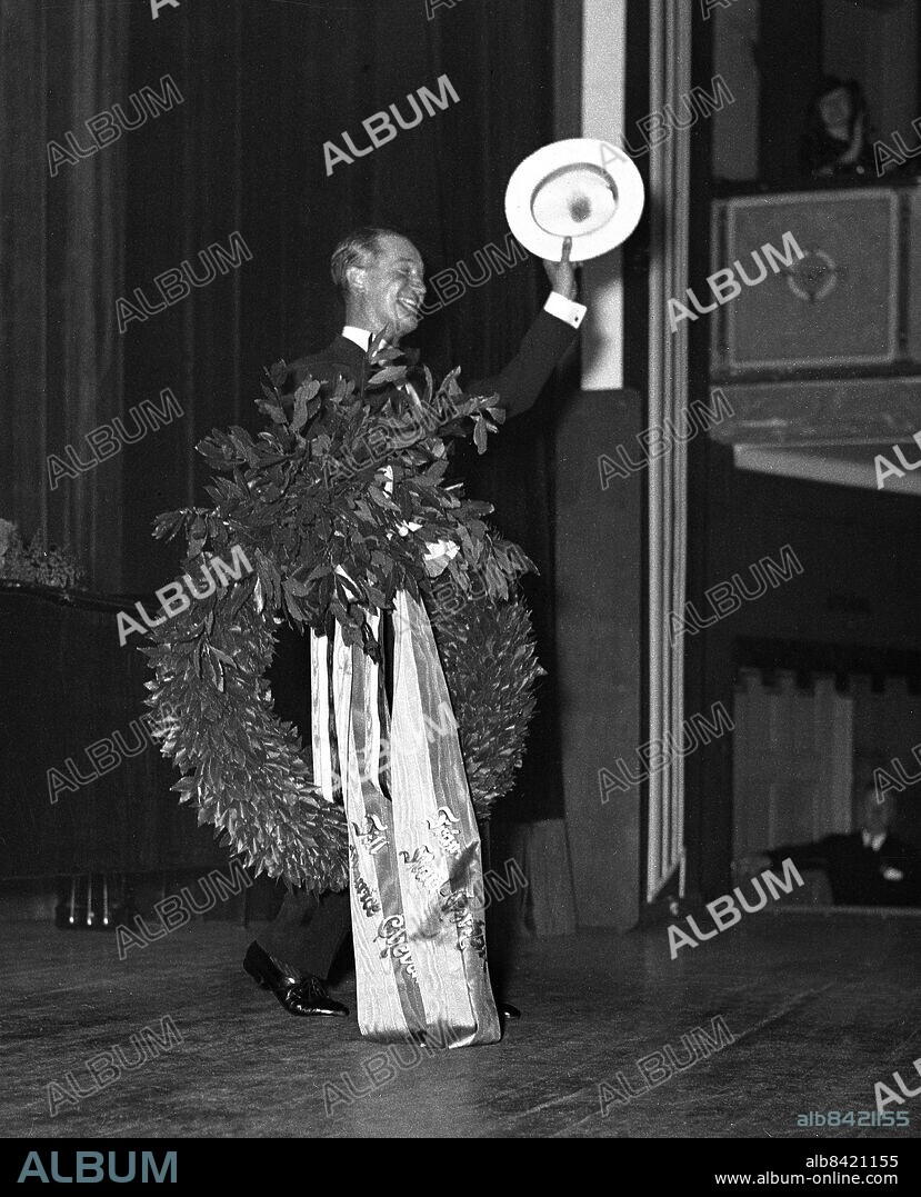 ARKIV 1938 . Maurice Chevalier(1888-1972) , fransk sångare, textförfattare och estradör som med sin halmhatt och putande underläpp charmade en hel värld. Här har han hyllats med en lagerkrans efter ett uppträdande på Auditorium.. Maurice Chevalier, popular French singer and actor.. Foto: TT / Kod 1900.