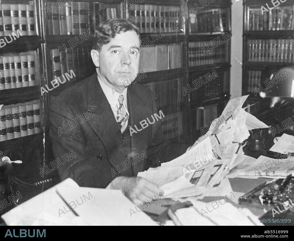 Huey Long Looks A Congratulations -- Senator Huey P. Long looks over a stack of letters and telegrams congratulating him on his "Every Man A King" Radio talk, made in Louisiana a few days ago. He is shown in his Washington, D.C. Office. January 11, 1935. (Photo by Associated Press Photo).