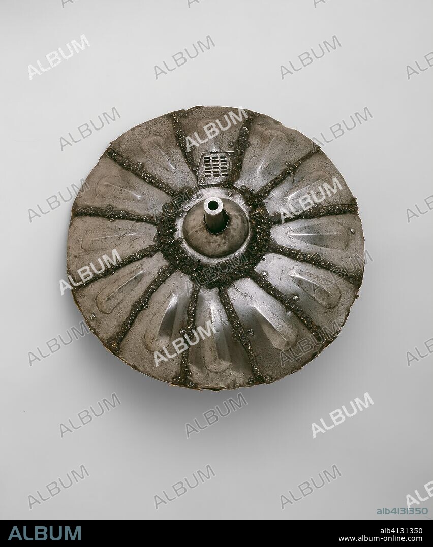 Gun Shield. Italian. Date: 1535-1545. Dimensions: Diameter 44.5 cm (17 1/2 in.) 
Wt. 10 lb. 9 oz.
Caliber .56. Steel, iron, wood, wool textile, and hemp fiber. Origin: Italy.
