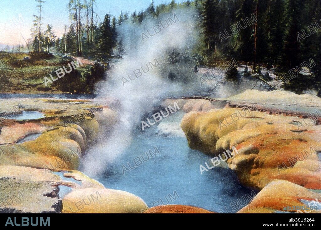 Oblong Geyser was named for the shape of its large oblong shaped pool. While technically a fountain-type geyser, Oblongs eruptions can't really be classified as bursting type eruptions. The eruptions are more like a very large and heavy boiling that covers the pool and raises the water in surges of 25 feet or more. Oblong is a major geyser. It is not too tall, usually the maximum height is around 25 feet but in exceptional eruptions it has reached 50 feet. What makes it a major geyser is the amount of water it puts out during its 5 minute eruption. Because the water flows almost directly into the Firehole river, it is not possible to measure the amount of water expelled during an eruption but it is estimated at over 10,000 gallons. That is a little more water than is expelled during a large eruption of Old Faithful. Yellowstone National Park is a national park located primarily in the state of Wyoming, although it also extends into Montana and Idaho. Photographed by Frank J. Haynes, no date.