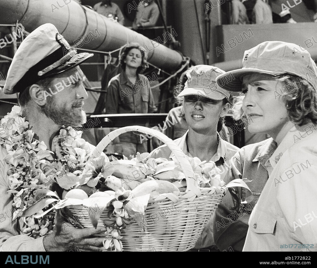 Kirk Douglas and Patricia Neal in the film 'In Harm's Way'. The US actor Kirk Douglas hands a basket of bananas and garlands to the actress Patricia Neal in a scene of the film 'In Harm's Way', where he plays the role of a naval commander. Hawaii (United States), 1965.