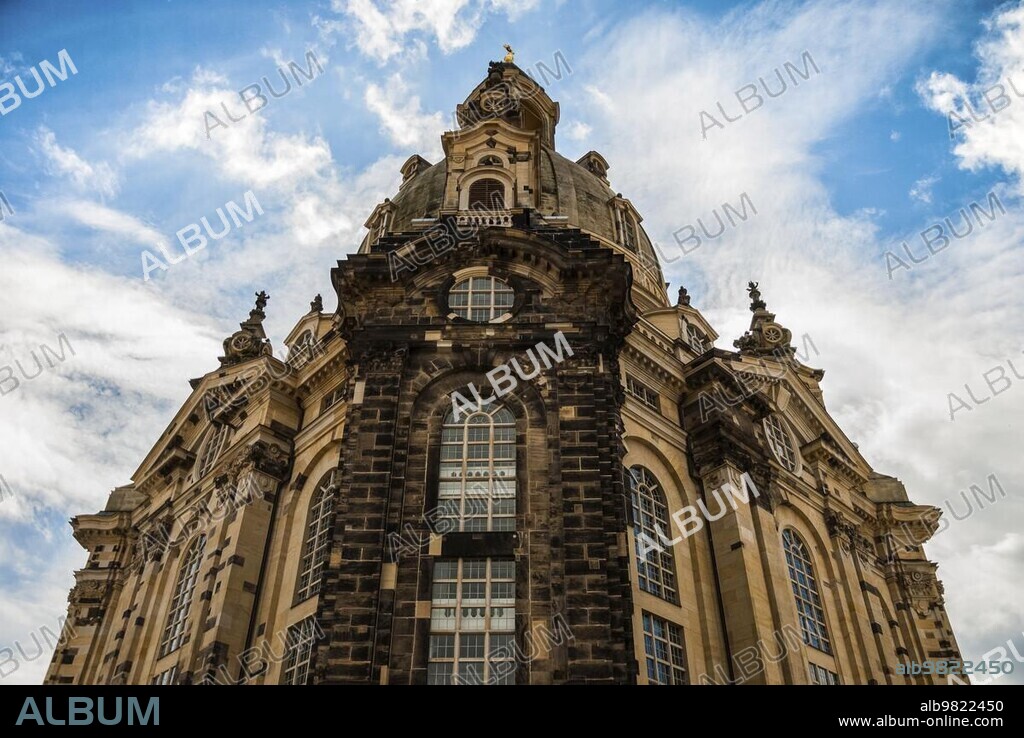 Facade of Frauenkirche (Our Lady church) in Dresden; Germany at day; upshot with great sky. Heavily ruined in WWII church was restored then. A masterpiece of Baroque and Classicism architecture in daylight. Blue sky and clouds on sunny spring day.