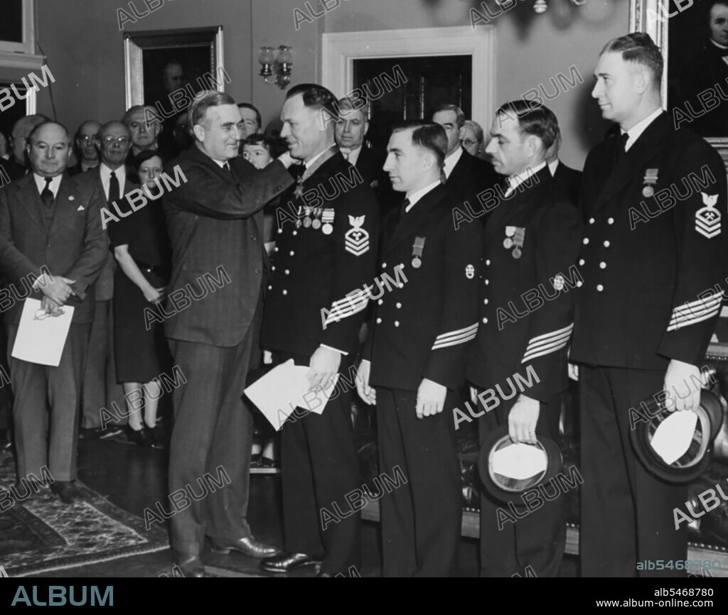 Secretary of the Navy Charles Edison presents Medals of Honor to Chief Machinist's Mate William Badders, Chief Torpedoman John Mihalowski, Chief Boatswain's Mate Orson L. Crandall and Chief Metalsmith James Harper McDonald on Jan. 19, 1940.