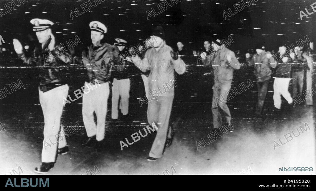 Officers and crewmen of the Pueblo being led ashore at Wonsan, North Korea, after their capture. January 1968.
