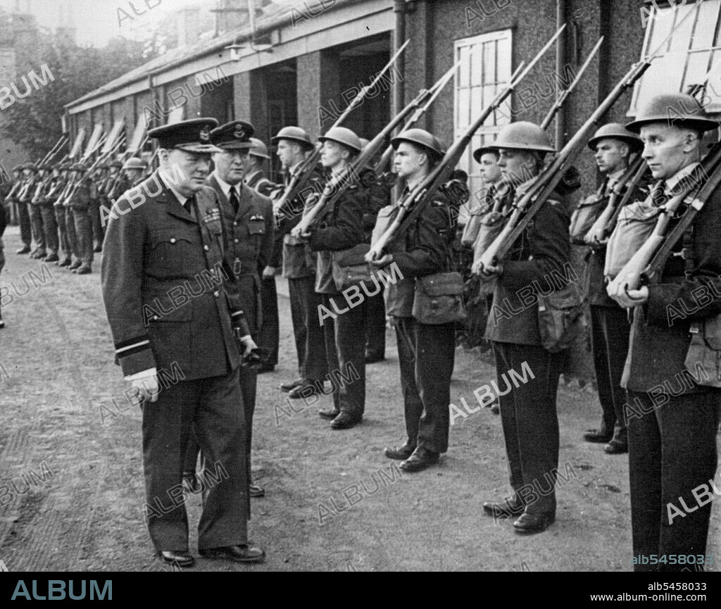 Air Commodore Churchill -- Inspected a R.A.F. guard of honour at the aerodrome.The Prime Minister wearing the uniform of Air Commodore of the Royal Air Force recently visited No. 615 Squadron of which he is honorary air commodore. He spent some time looking round the aerodrome and had tea with officers in the Mess. He was accompanied by Mrs. Churchill. September 30, 1941. (Photo by British Official Photograph).