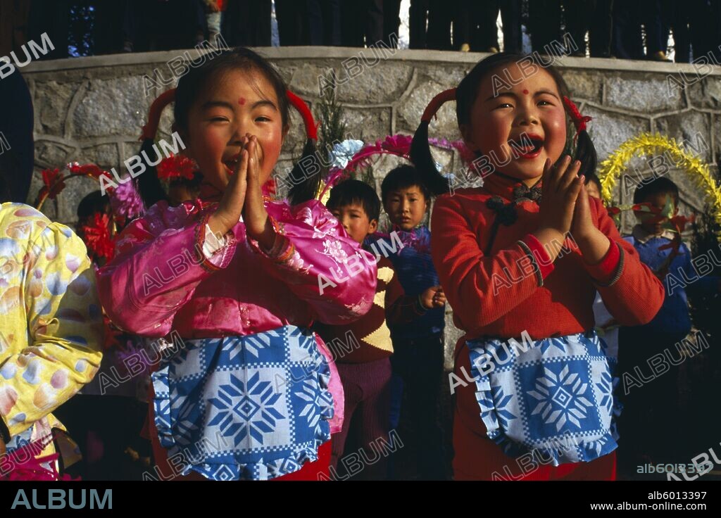 CHINA Yunnan Province Tribal People Two small girls performing song.