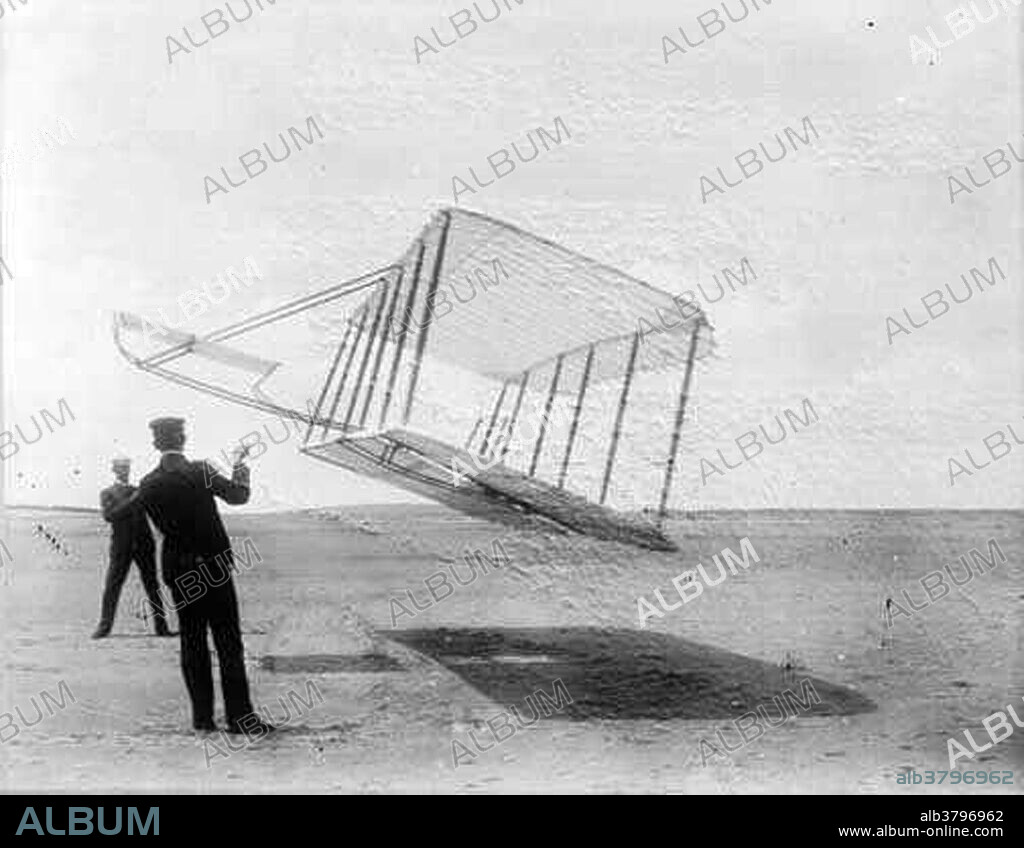 Orville (foreground) and Wilbur (background) Wright, flying a test glider as a kite in 1901. These tests along with manned flights and wind tunnel experiments allowed the brothers to construct the first ever powered flight aircraft, which they flew at Kill Devil Hill, Kitty Hawk, North Carolina, USA, in 1903.