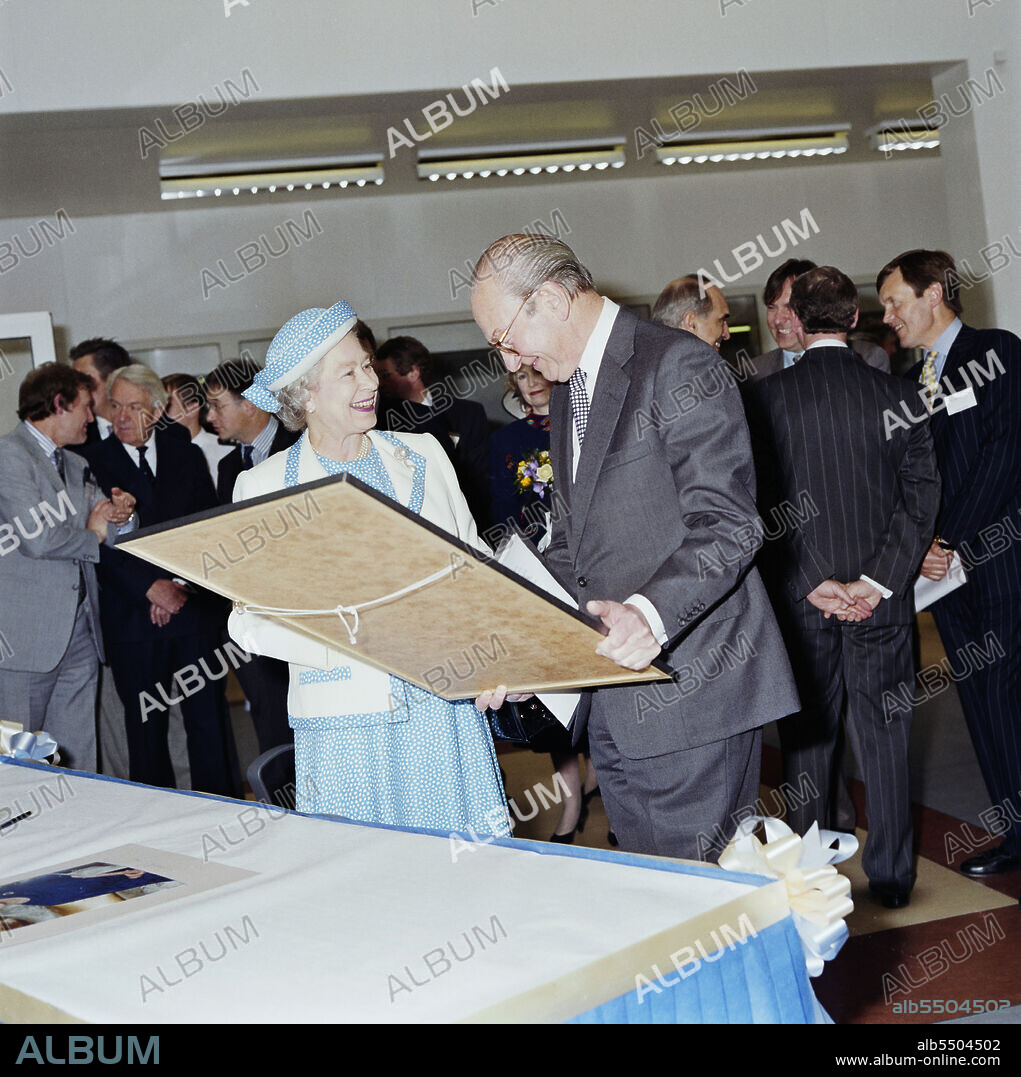 JOHN LAING PLC. Chelsea and Westminster Hospital, Fulham Road, Kensington and Chelsea, London, 13/05/1993. Sir William Doughty presenting Her Majesty Queen Elizabeth II with a framed photograph of Chelsea and Westminster Hospital, on the day of the official opening. At the time this photograph was taken, Sir William Doughty was chairman of North West Thames Regional Health Authority. This image was published in the July 1993 issue of Laing's monthly 'Team Spirit' newsletter. Laing Management Contracting worked on the construction of Chelsea and Westminster Hospital on behalf of the North West Thames Regional Health Authority between 1989 and 1993. The new teaching hospital was built on the site of the old St Stephen’s Hospital, which was demolished in the early months of 1989. The use of fast track construction techniques enabled the entire project to be completed in less than 5 years, and the hospital was officially opened by the Queen on 13 May 1993.