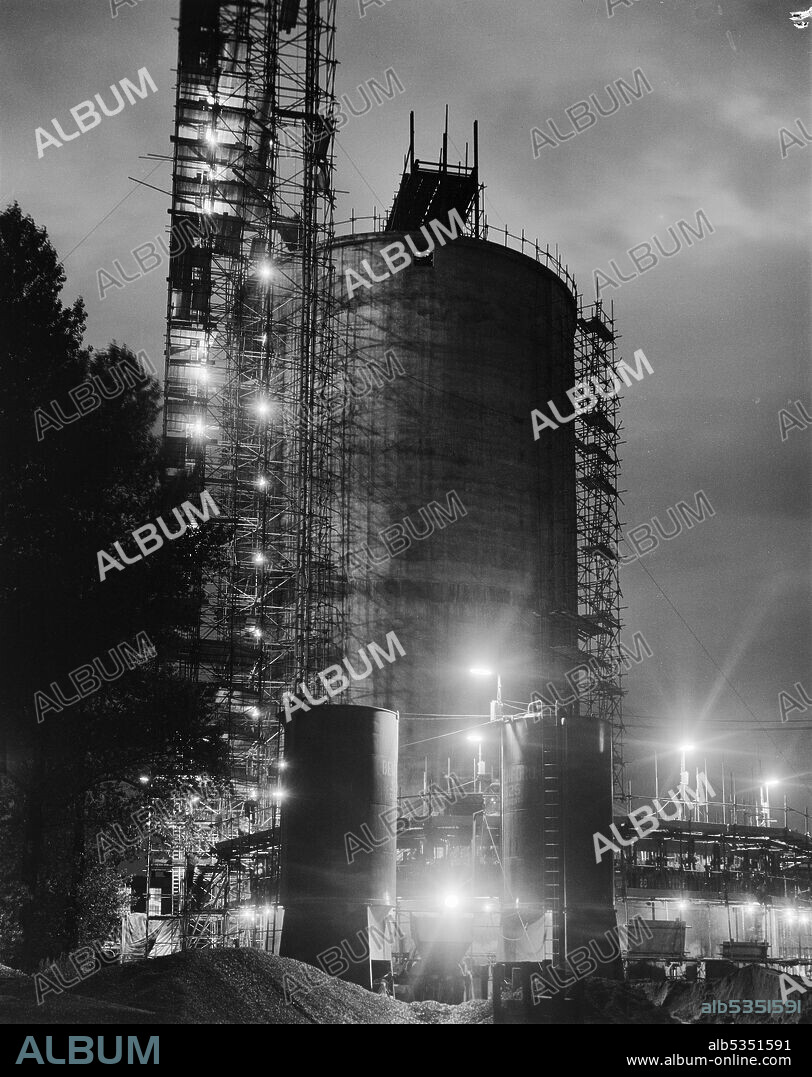 JOHN LAING PLC. A floodlit view of a sugar silo under construction at Allscott Sugar Beet Factory. A sugar beet factory was at Allscott from 1927 until it closed in 2007. Laing built two sugar silos here in 1961 for the British Sugar Corporation who were the owners of the site. Each silo was able to store 10,000 tons of granulated sugar and at the time they were constructed, they were the tallest that Laing had built so far using sliding formwork. This photograph was published in September 1961 in the Laing monthly newsletter 'Team Spirit'.