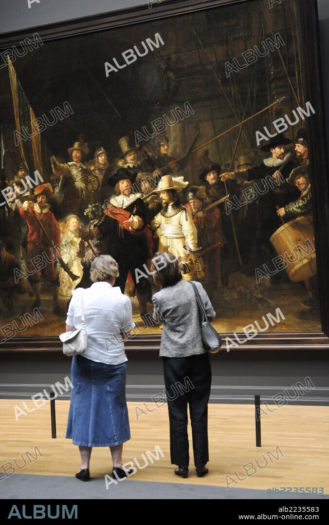 Holland. Amsterdam. Rijksmuseum. Women looking The Night Watch, painting by Rembrandt Harmenszoon van Rijn (1606-1669).