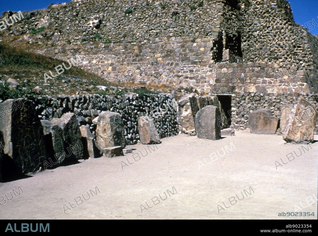 standing figures of the "Los Danzantes" a collection of more than 300 bas-reliefs at Monte Alban. Monte Alban, is a large pre-Columbian archaeological site in the Santa Cruz Xoxocotlan Municipality in the southern Mexican state of Oaxaca. Besides being one of the earliest cities of Mesoamerica, Monte Alban's importance stems also from its role as the pre-eminent Zapotec socio-political and economic center for close to a thousand years. Founded toward the end of the Middle Formative period at around 500 BC. One characteristic of Monte Alban is the large number of carved stone monuments one encounters throughout the plaza. The earliest examples are the so-called "Danzantes" (literally, dancers), The figures are said to represent sacrificial victims.