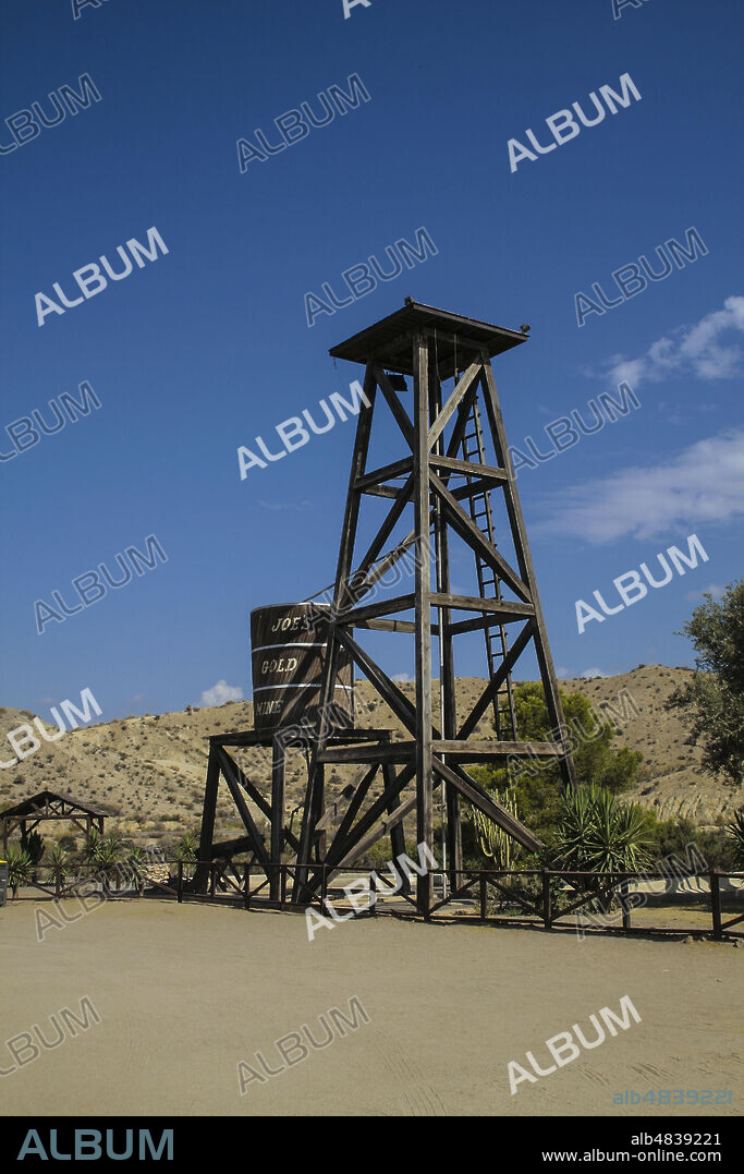 Province of Almería, Andalusia, Spain, Europe. Tabernas Desert (Desierto de Tabernas). Mini Hollywood film set, western theme park. Far West town. A wooden tower and a cistern in a mining area.