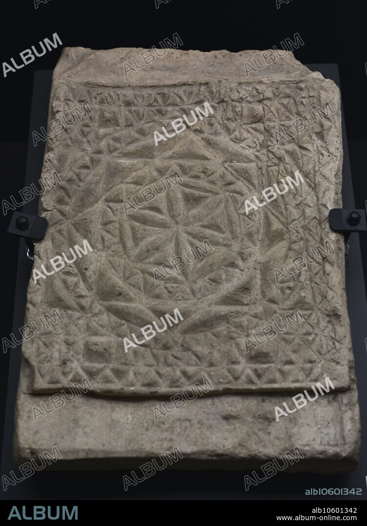Placa o ladrillo con decoración en relieve de motivo religioso. Crismón con decoración geométrica. Barro cocido. Siglos IV-V. Procedencia desconocida. Museo de los Concilios y la Cultura Visigoda. Toledo. Castilla-La Mancha. España.