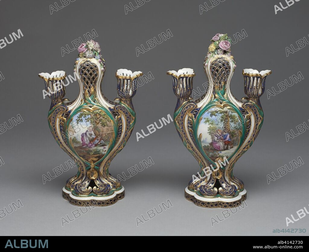 MANUFACTURE NATIONALE DE SEVRES. Pair of Vases (Pots Pourris à Bobèches). Sèvres Porcelain Manufactory; French, founded 1740; Designed by Jean-Claude Duplessis; (French, fl. 1745/48-1774, died 1783); Painted by André-Vincent Vieillard (attributed to); (French, 1717-90, active 1752-90). Date: 1754-1764. Dimensions: 1994.371.1: H. 24.1 cm (9 1/2 in.)
1994.371.2: H. 25.2 cm (9 7/8 in.). Soft-paste porcelain, polychrome enamels, and gilding. Origin: Sèvres.