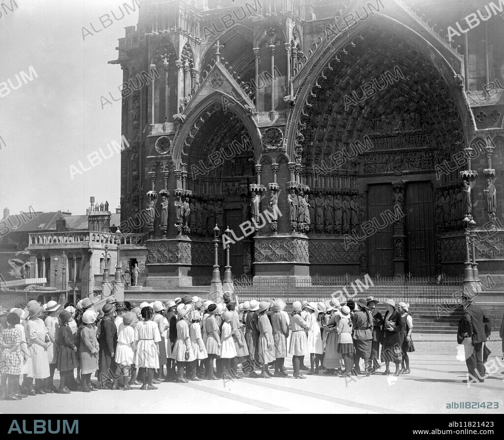 A party of English schoolgirls under the guidance of the British League of help visit the devastated area of France. At Aminens Cathedral. 9 August 1923.