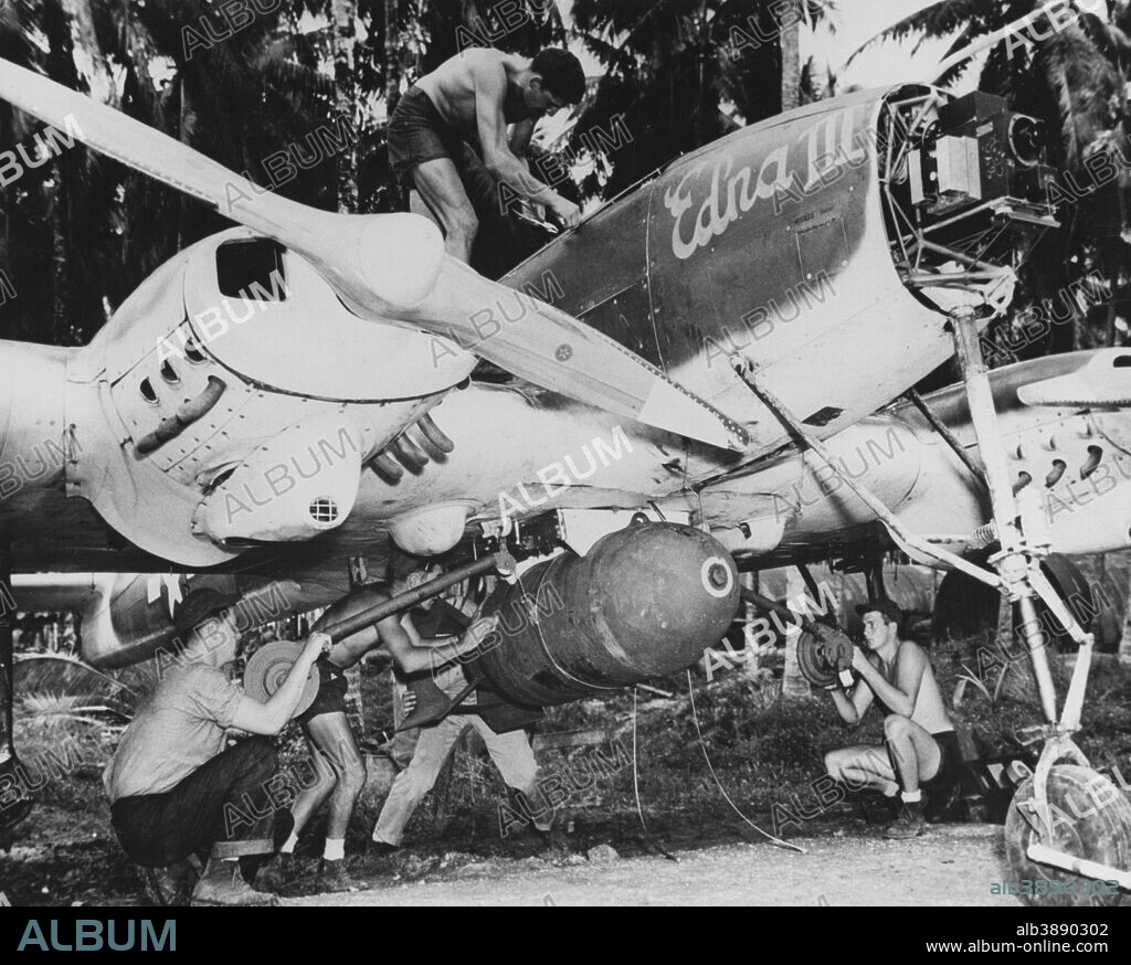 Interstate TDR-1 assault drone being prepared for attack. During September and October 1944, Special Task Air Group One (STAG-1) operated TDR-1s from Banika, Russell Islands, in combat action against enemy targets in the Solomons area. This photograph was probably taken during this time. Note the bomb being hoisted into position under the drone's fuselage, the name Edna III on the side of its nose, and television guidance equipment inside the nose.