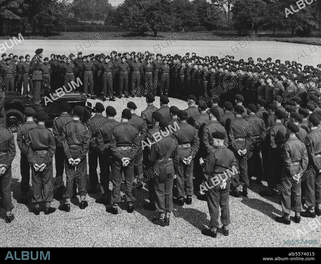 Monty Addresses Paratroopers: King Approves New Monto "Ready For Anything" - Lord Montgomery, colonel-commandant of the Parachute regiment, is seen standing in a jeep on the parade ground at Albuhera Barracks, Aldershot, addressing officers and men of the 16th. Independent Parachute Bridge, June 3.Tomorrow, the brigade leaves for Cyprus.A small number of soldiers in the right place is better than a large number in the wrong place, he told them when referring to the east as a trouble spot. The field-marshal also informed the men that the king had approved of a Motto for the parachute regiment. The new Motto is "Utrinque Paratus" which means "Ready for anything". July 12, 1951. (Photo by Associated Press Photo).