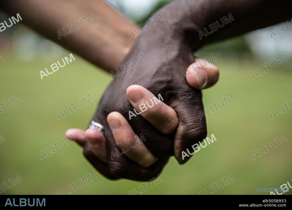 July 16, 2020, Abbotsford, British Columbia, Canada: JULIE and LYNT holding hands at the border park where they meet. On April 12, when Julie Arps first messaged Lynt Harris on dating app Plenty of Fish, the world around them was growing increasingly unrecognizable due to the ongoing Coronavirus pandemic. (Credit Image: © David TesinskyZUMA Wire).